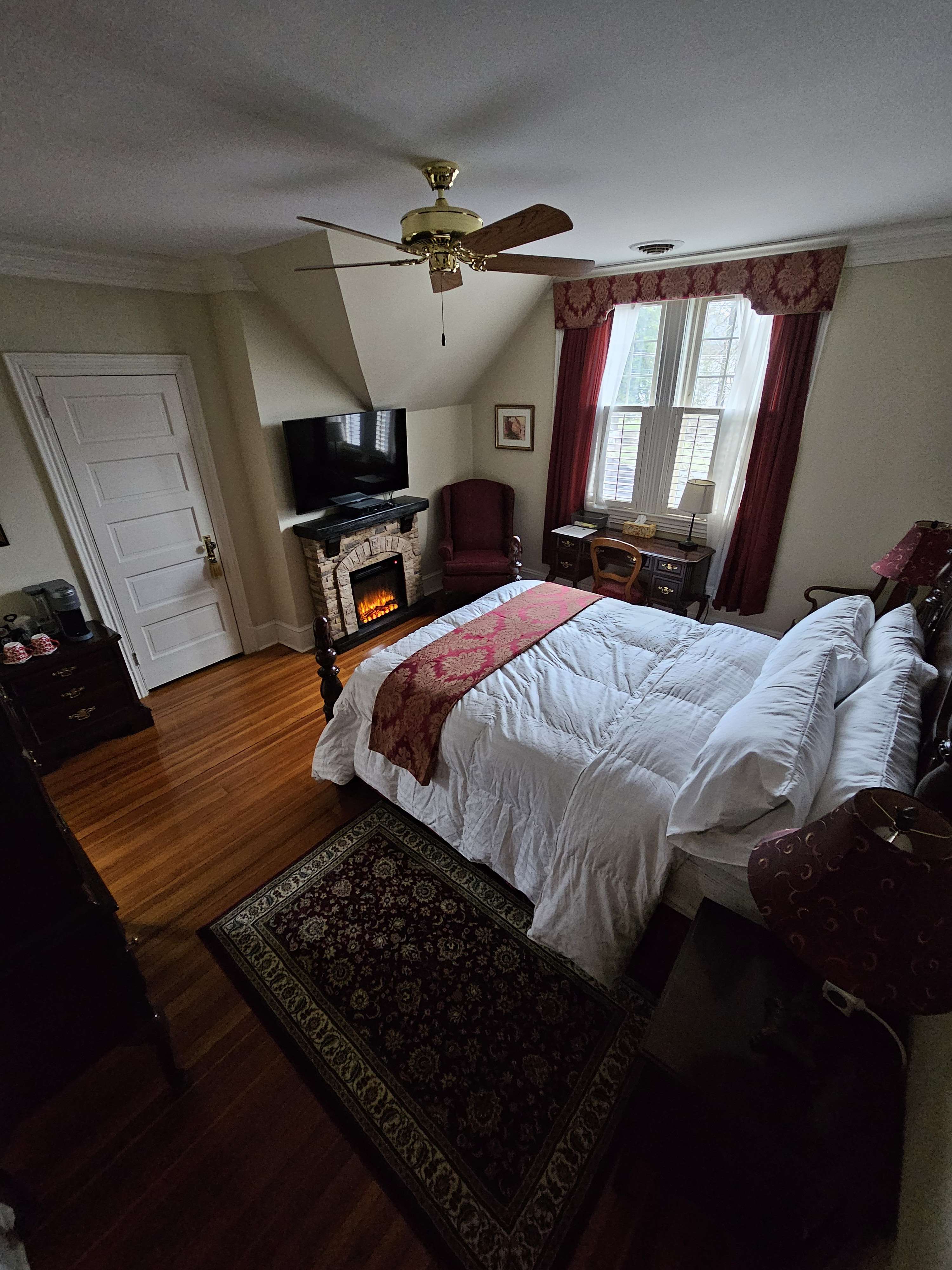 Red room bed, fireplace and TV